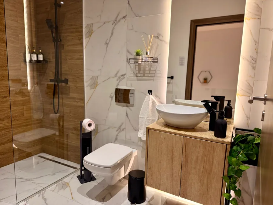 Elegant bathroom with modern tiling and multi-function shower
